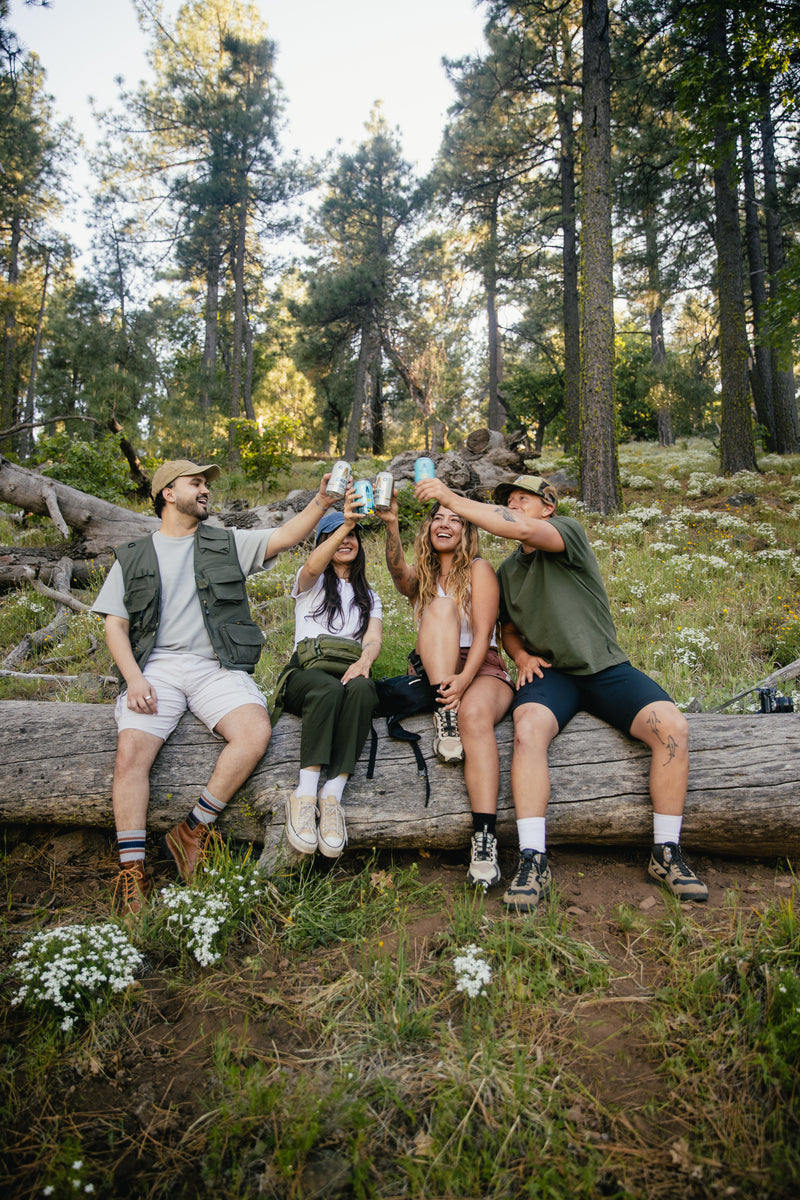 friends cheering brews in nature